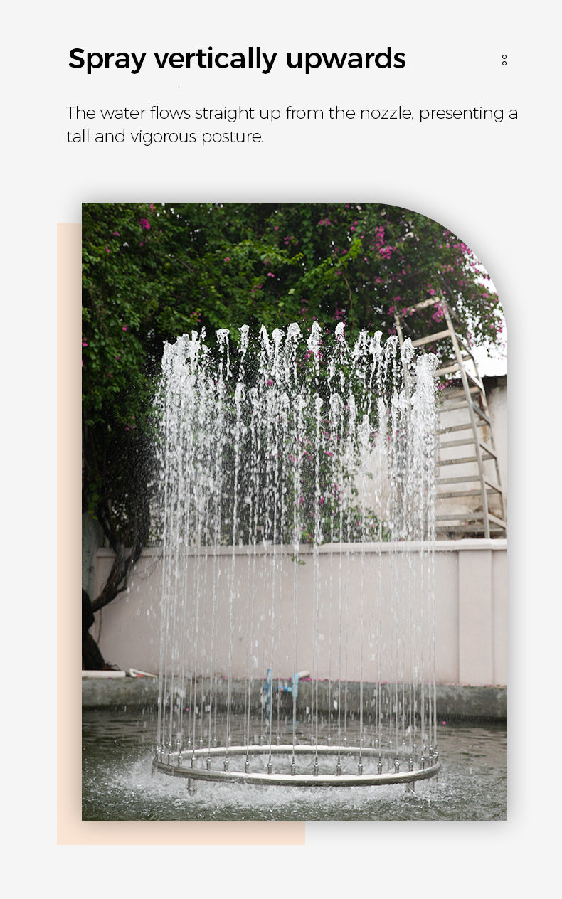 Fountain with water spraying vertically upwards from a nozzle, surrounded by greenery.