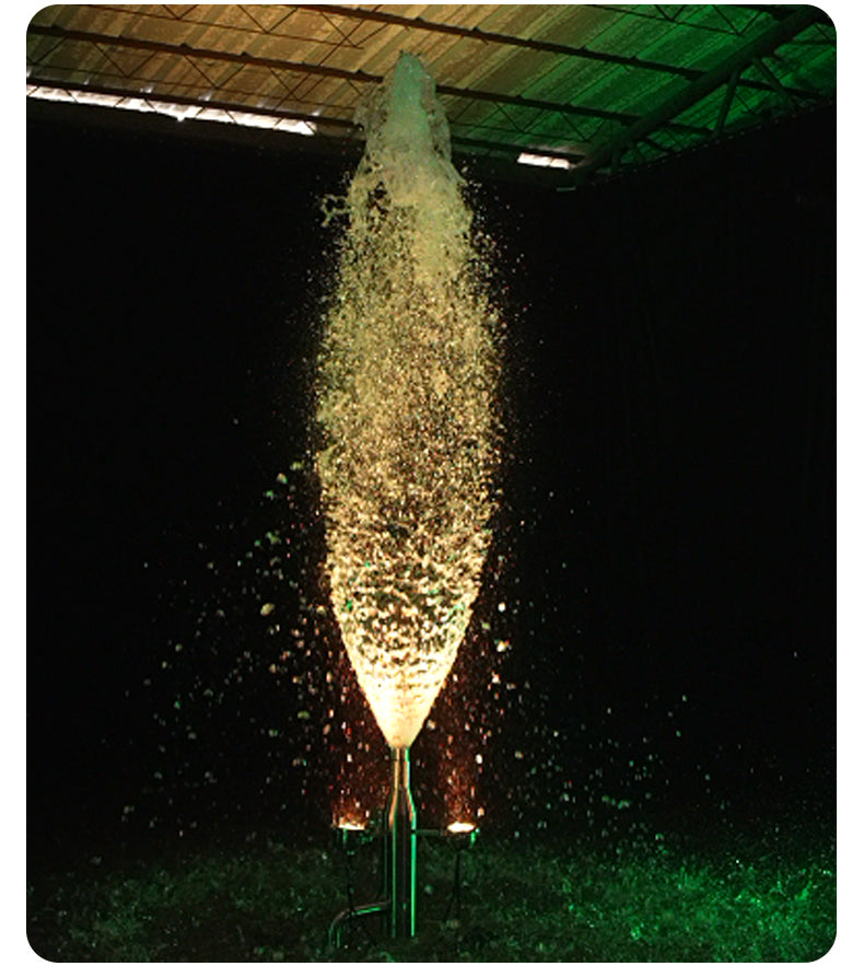 Fountain with water spray in a dark indoor setting