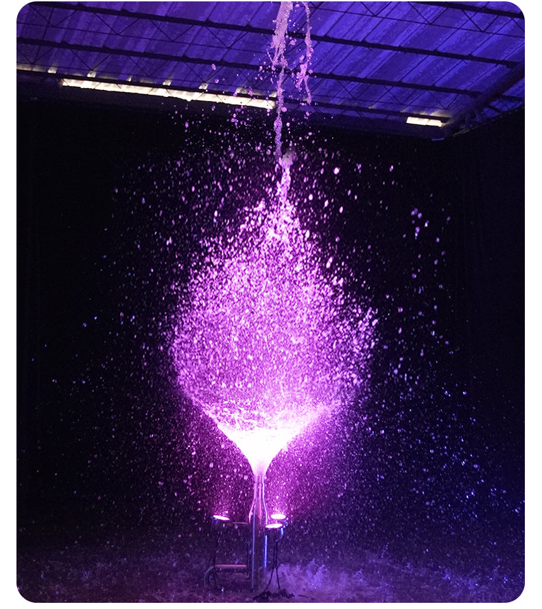 Purple water fountain in a dark indoor setting