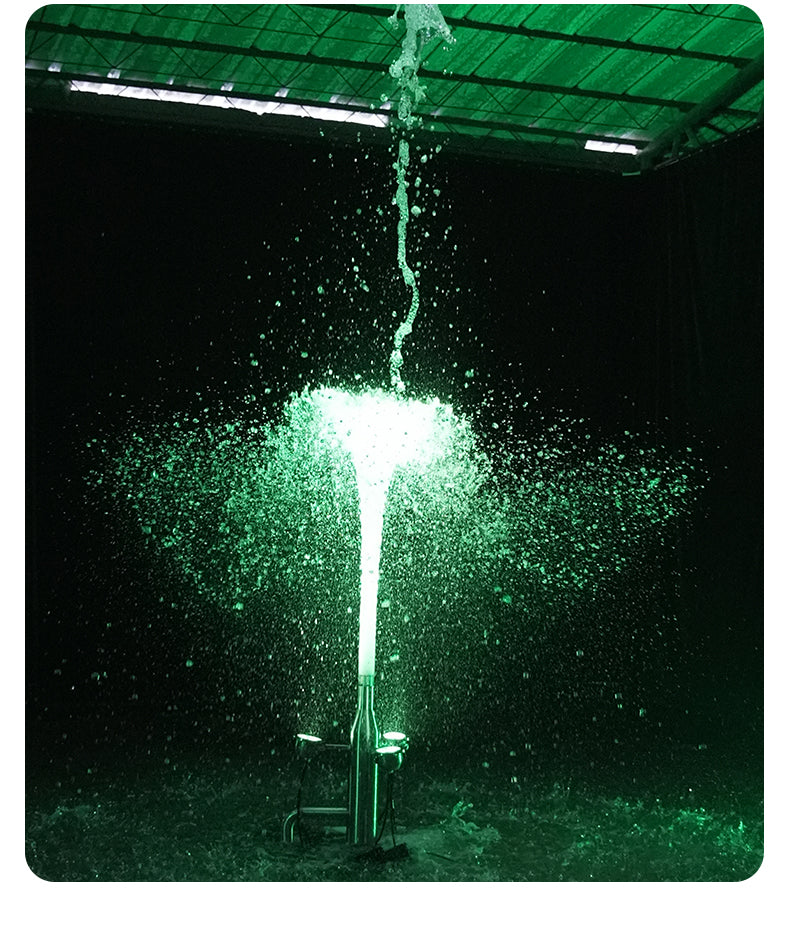 Green light fixture with water splashing around it against a dark background