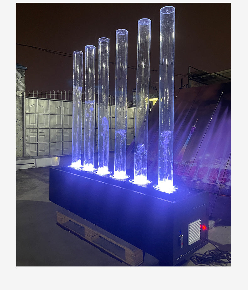 Lighted cylindrical columns on a platform at night